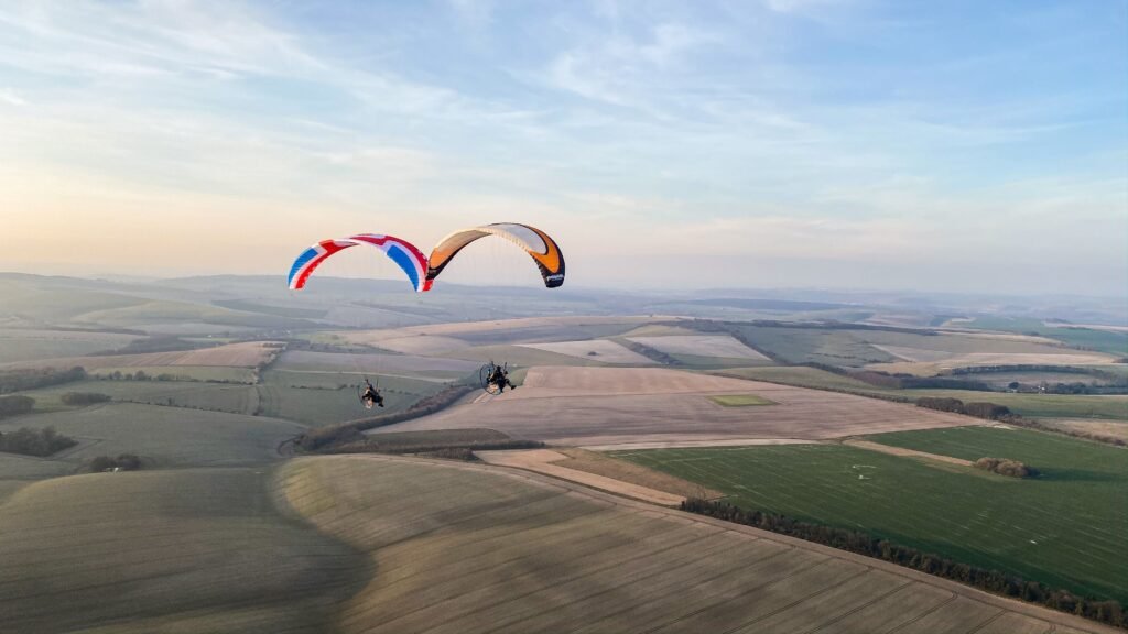 Two paramotors tip touching on a summer's evening in the UK. Learn to Fly paramotors with Sky Riders BHPA Paramotor school