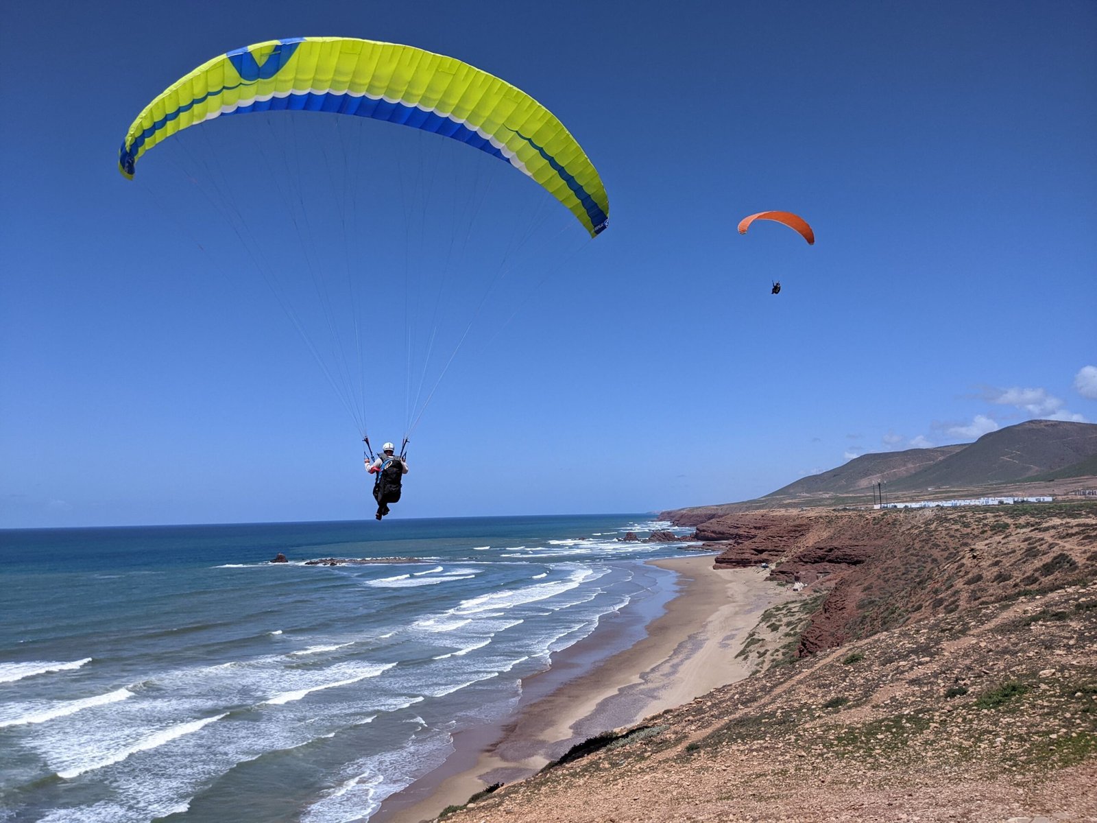 2 paragliders soaring the beaches in morocco with Sky Riders