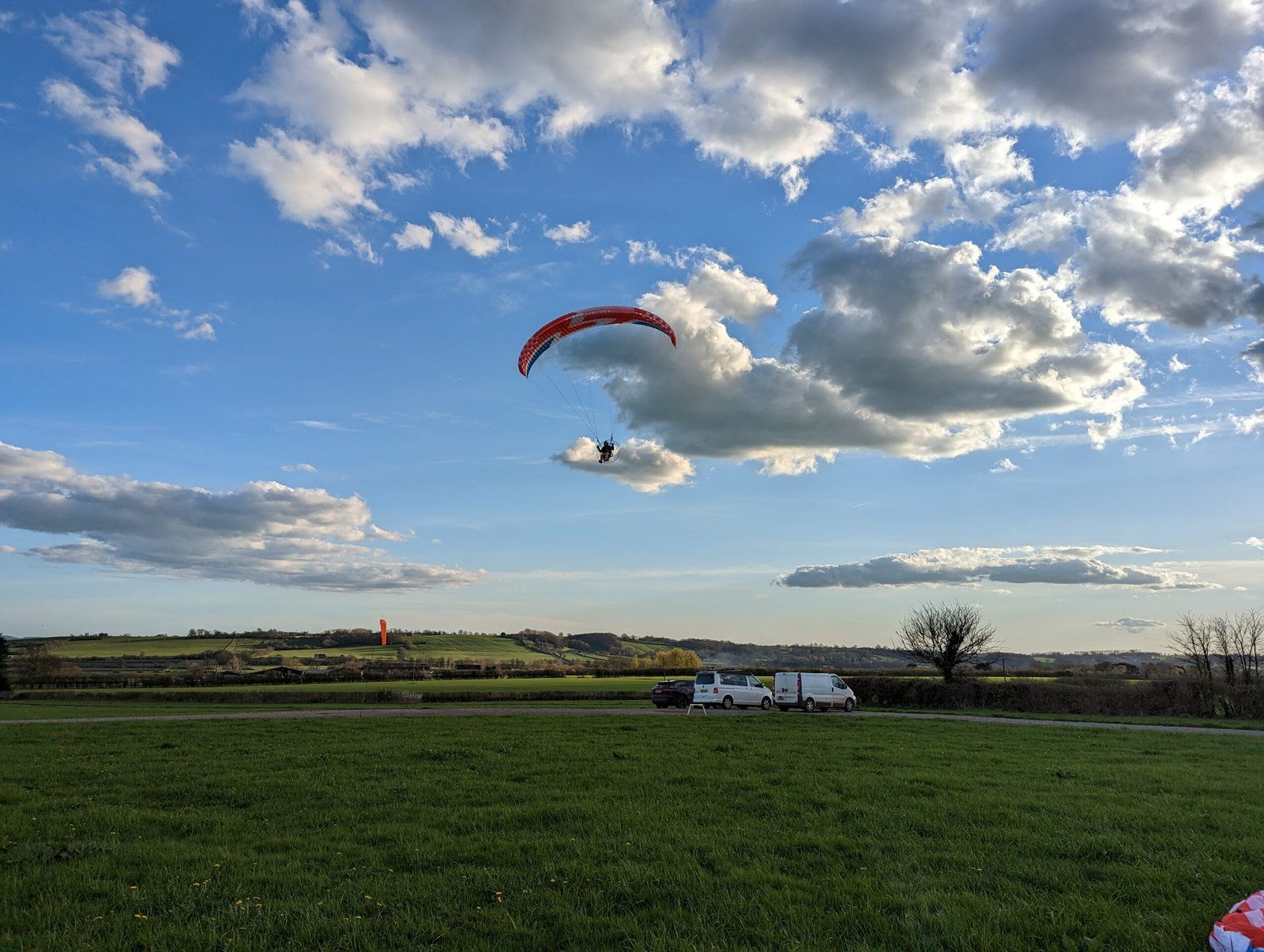 A paramotor coming in to land after an epic cross country flight on the pilot rating course with sky riders at the bath & west showground near glastonbury